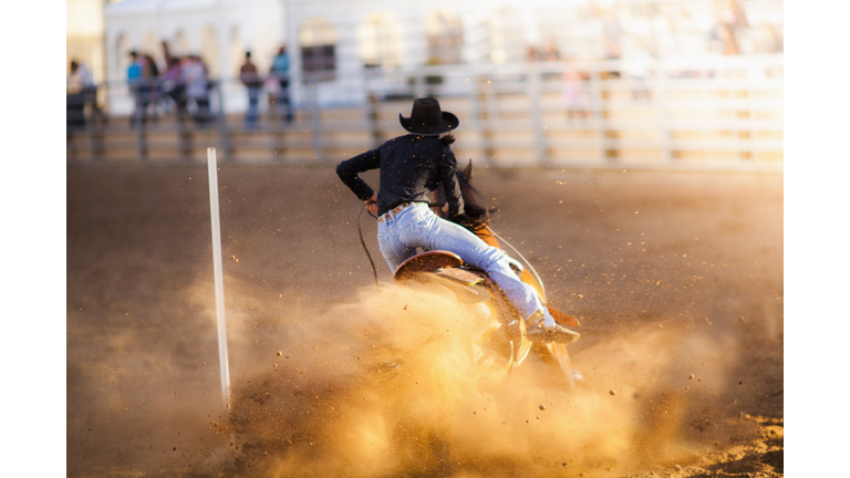 Women barrel racing at a rodeo