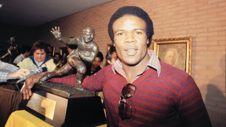 Charles White Posing with Heisman Trophy