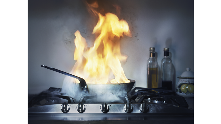 Burning frying pan in kitchen