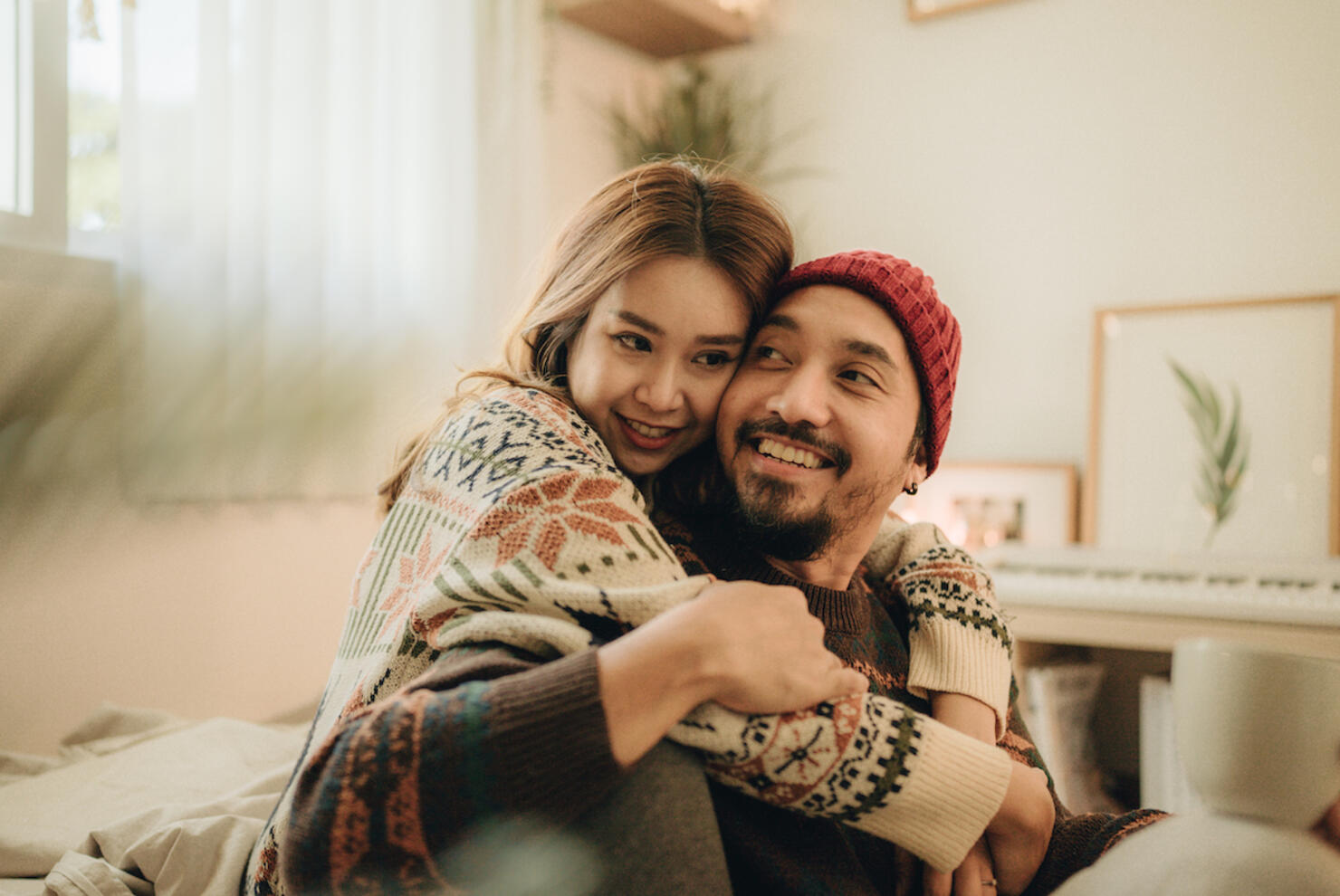 Happy young couple relaxing talking laughing drinking coffee tea