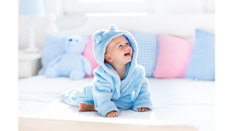 Little baby in bathrobe or towel after bath
