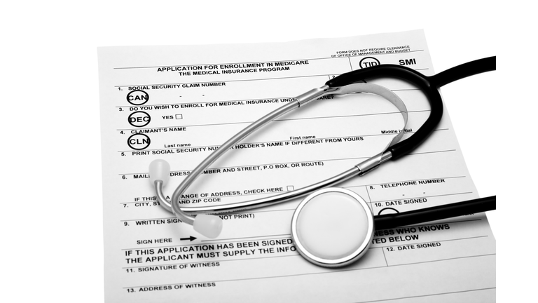Medicare Application for enrollment with Stethoscope on white background