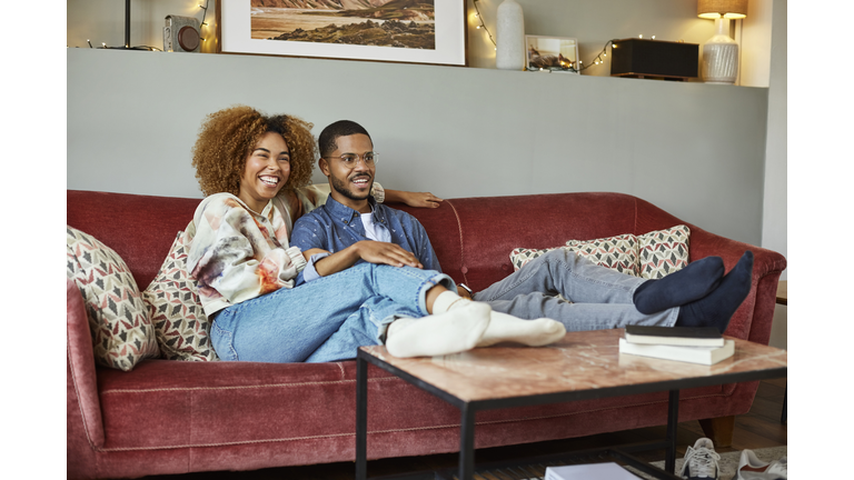 Young Couple Watching TV In Living Room