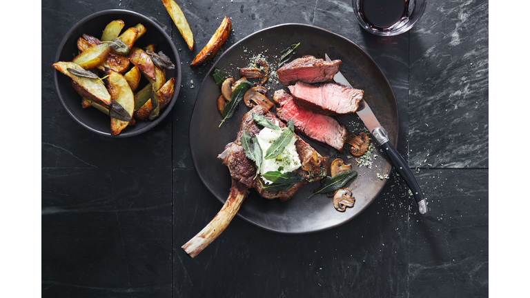 Tomahawk beef steak with mushrooms, burrata and sage potato wedges