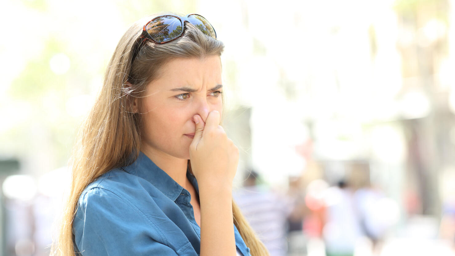 Girl covering her nose due to bad odour