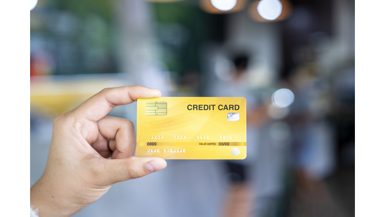 Woman hand holding a credit card at the shop