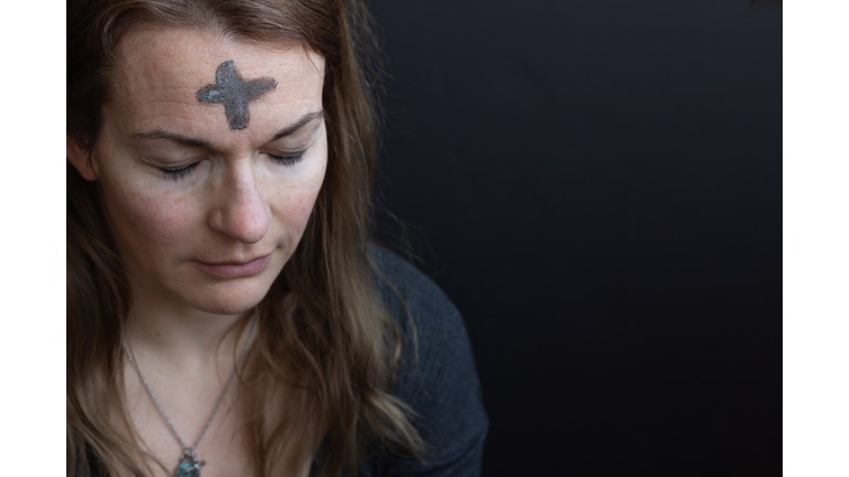 Woman with ash cross on forehead