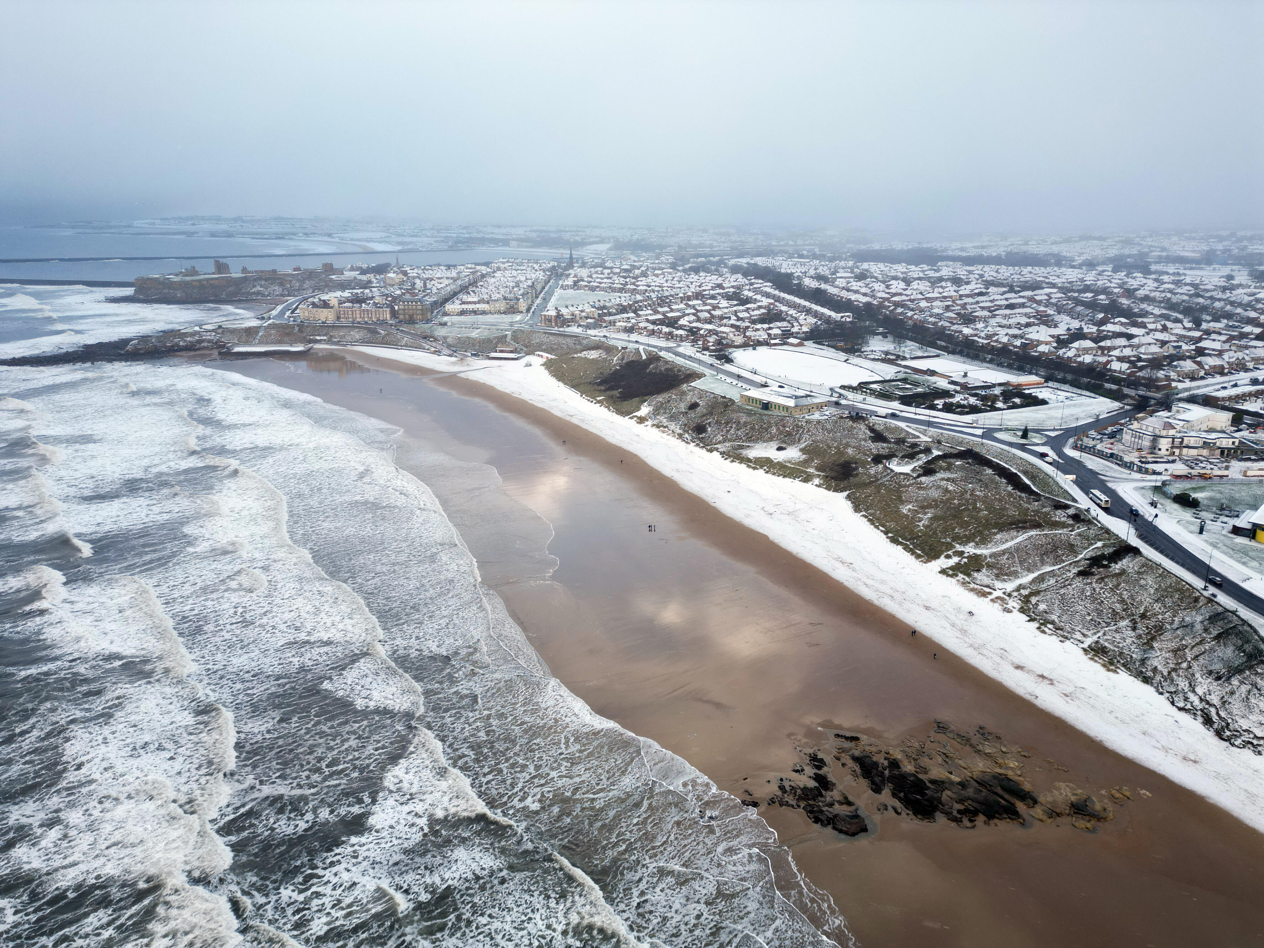 watch-sea-meet-snow-on-california-beach-during-rare-winter-storm-iheart