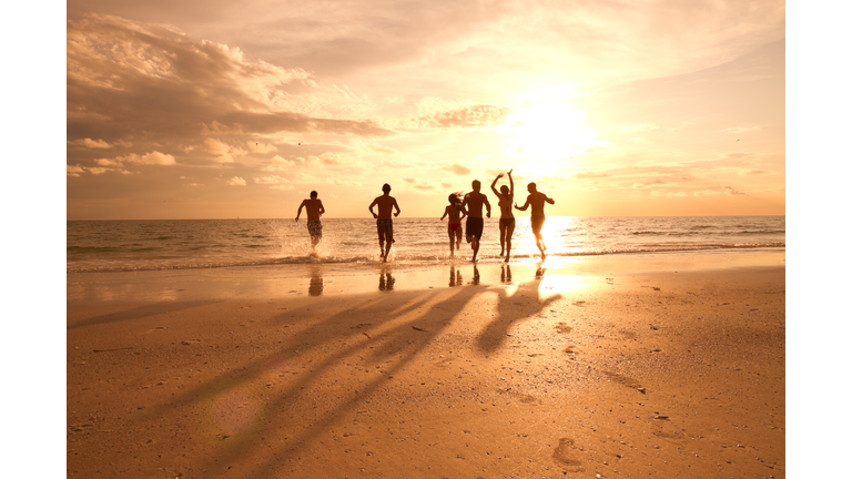 Group of multi ethnic friends having fun at the beach