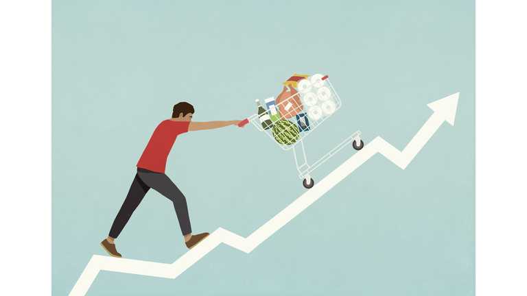 Man pushing shopping cart of groceries up line chart arrow