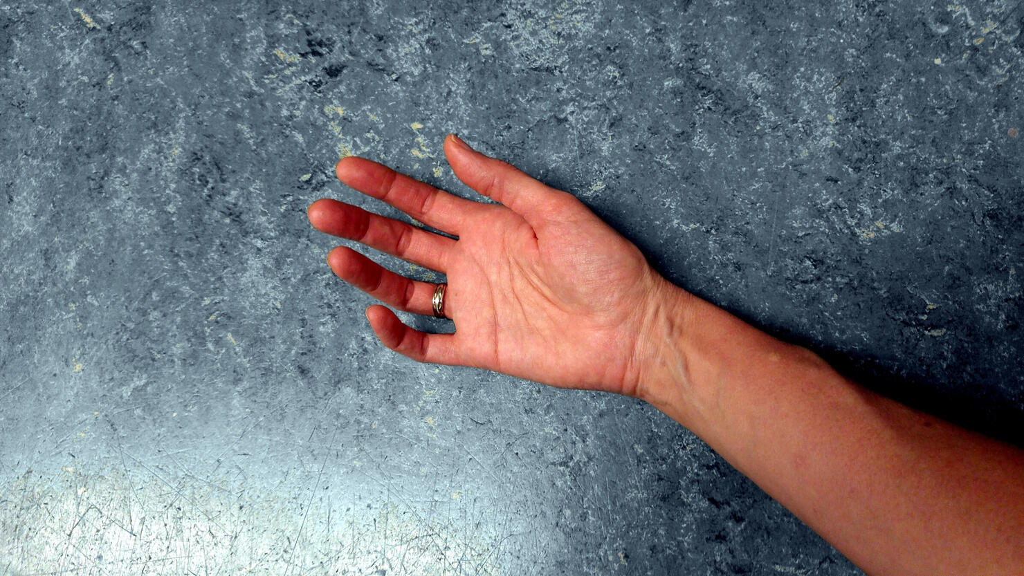Cropped Hand Of Man On Marble Floor