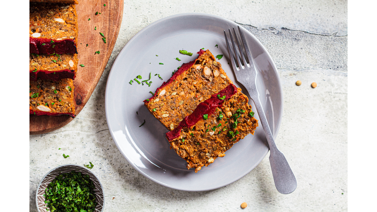 Lentil vegan meatloaf slices on gray plate. Christmas plant-based recipe.