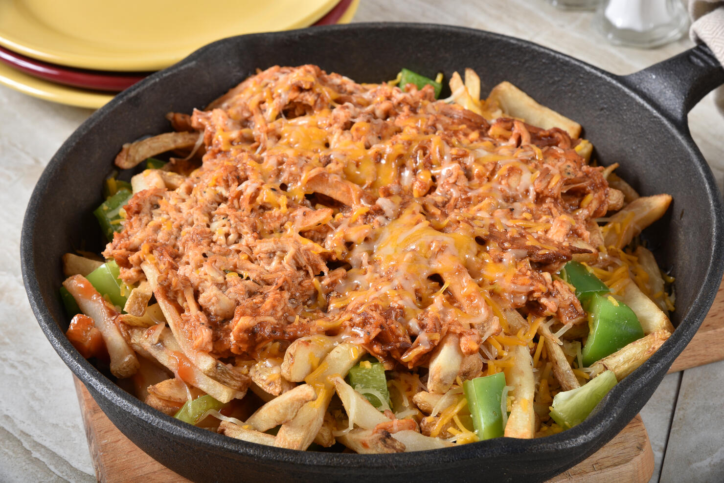 Loaded french fries in a cast iron skillet