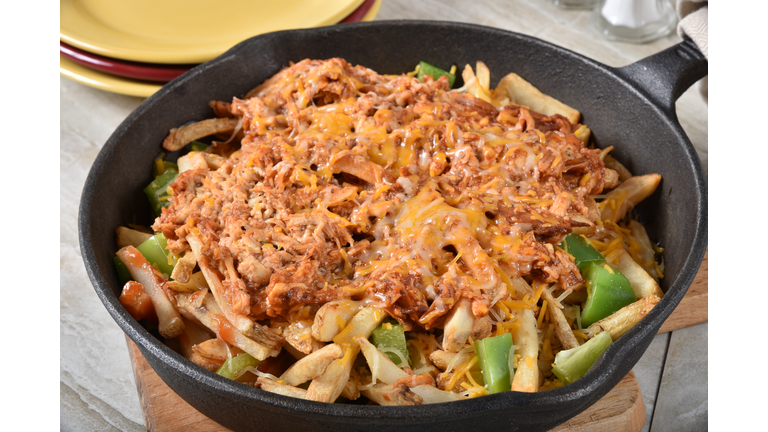 Loaded french fries in a cast iron skillet