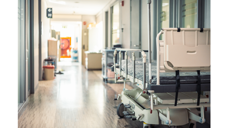 Empty hospital beds in hospital corridor