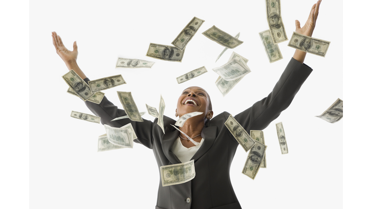 African American businesswoman throwing money in the air
