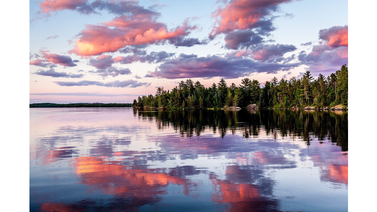 Reflection Of Trees In Lake Against Sky During Sunset