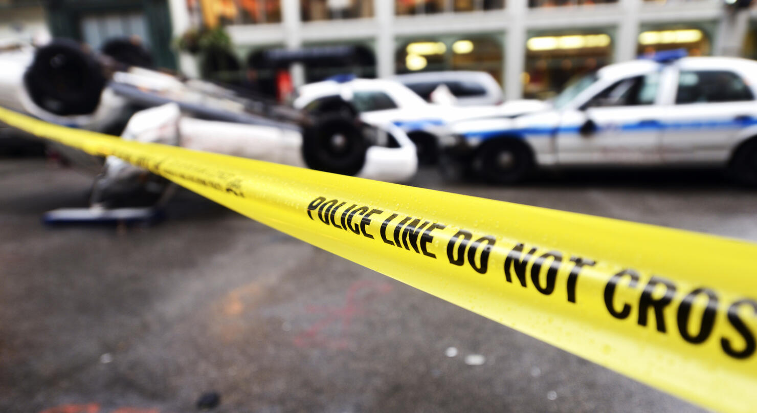 Police cars crash on crossroad.