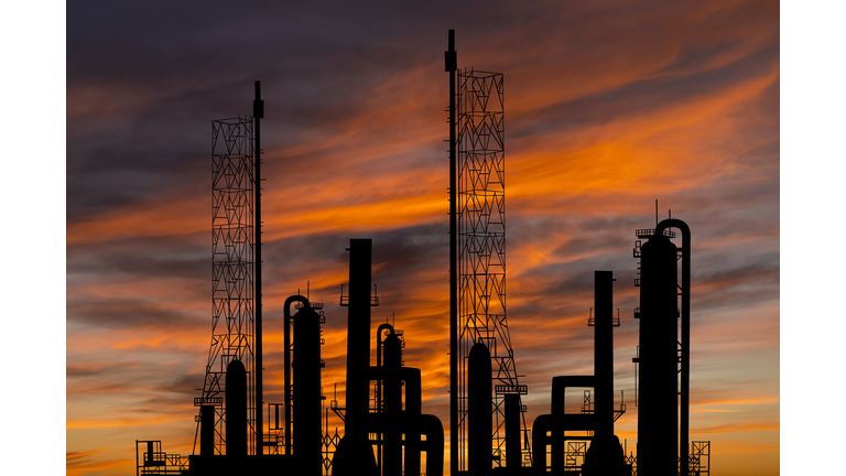 Oil refinery plant of petroleum or petrochemical industry production at sunset