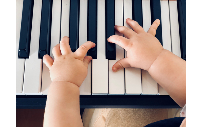 Cropped Hands Of Baby Playing Piano