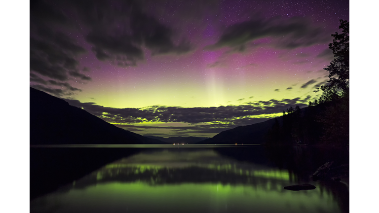 A multi colored aurora borealis display reflected in Mabel Lake, British Columbia, Canada