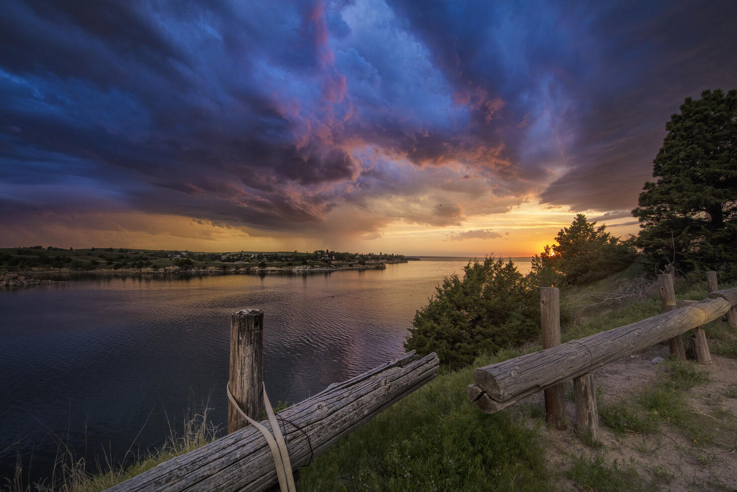 Fading supercell over lake at sunset, Ogallala, Nebraska, US