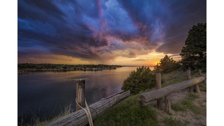 Fading supercell over lake at sunset, Ogallala, Nebraska, US