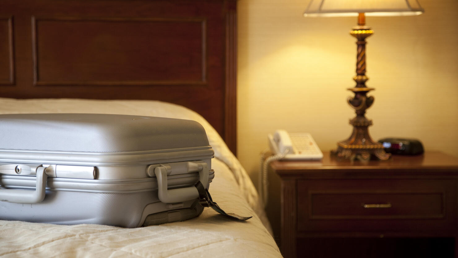 suitcase on bed in hotel room