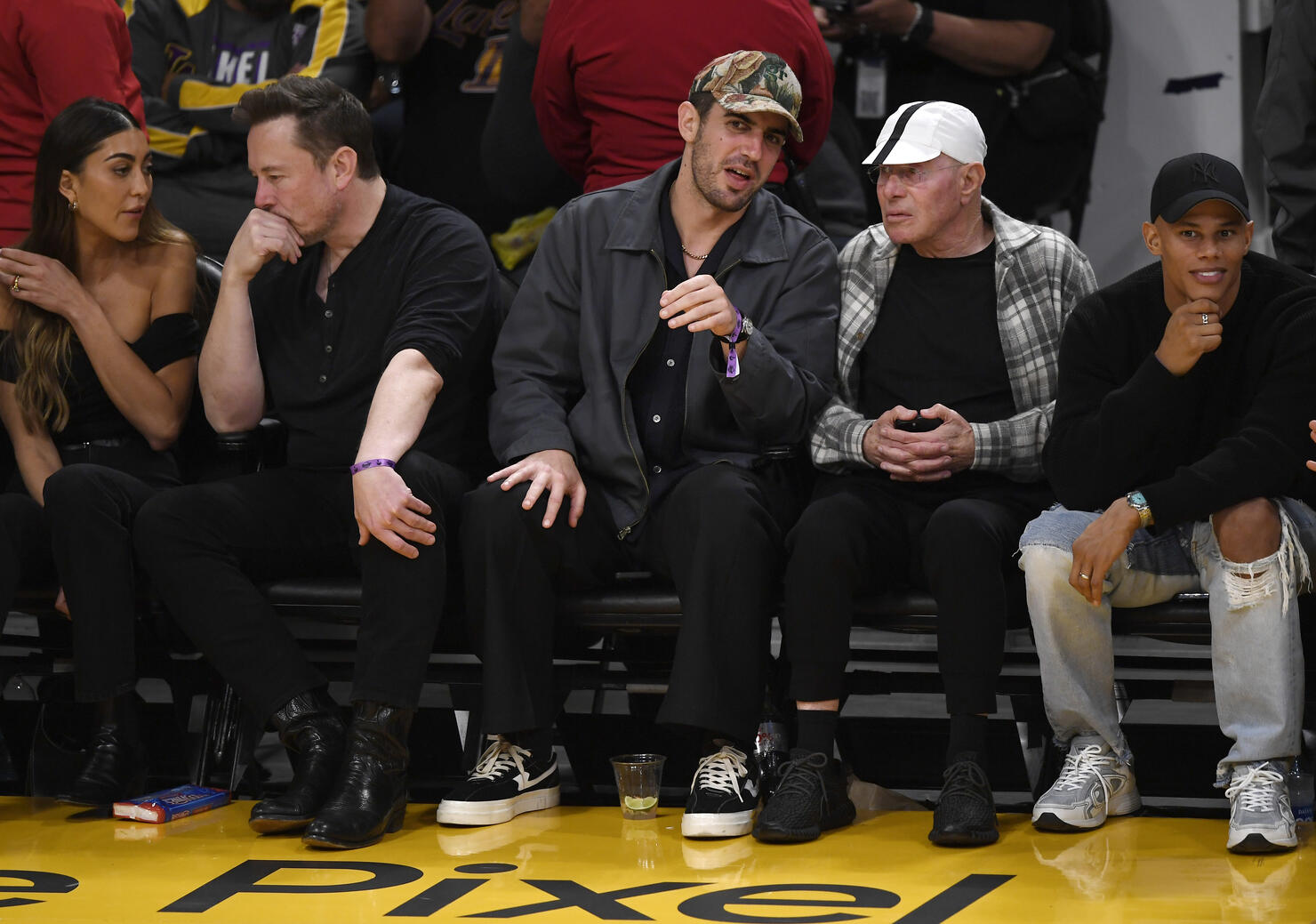 Kendall Jenner, center, sits courtside with Bad Bunny during the second  half in Game 6 of an NBA basketball Western Conference semifinal series  between the Los Angeles Lakers and the Golden State