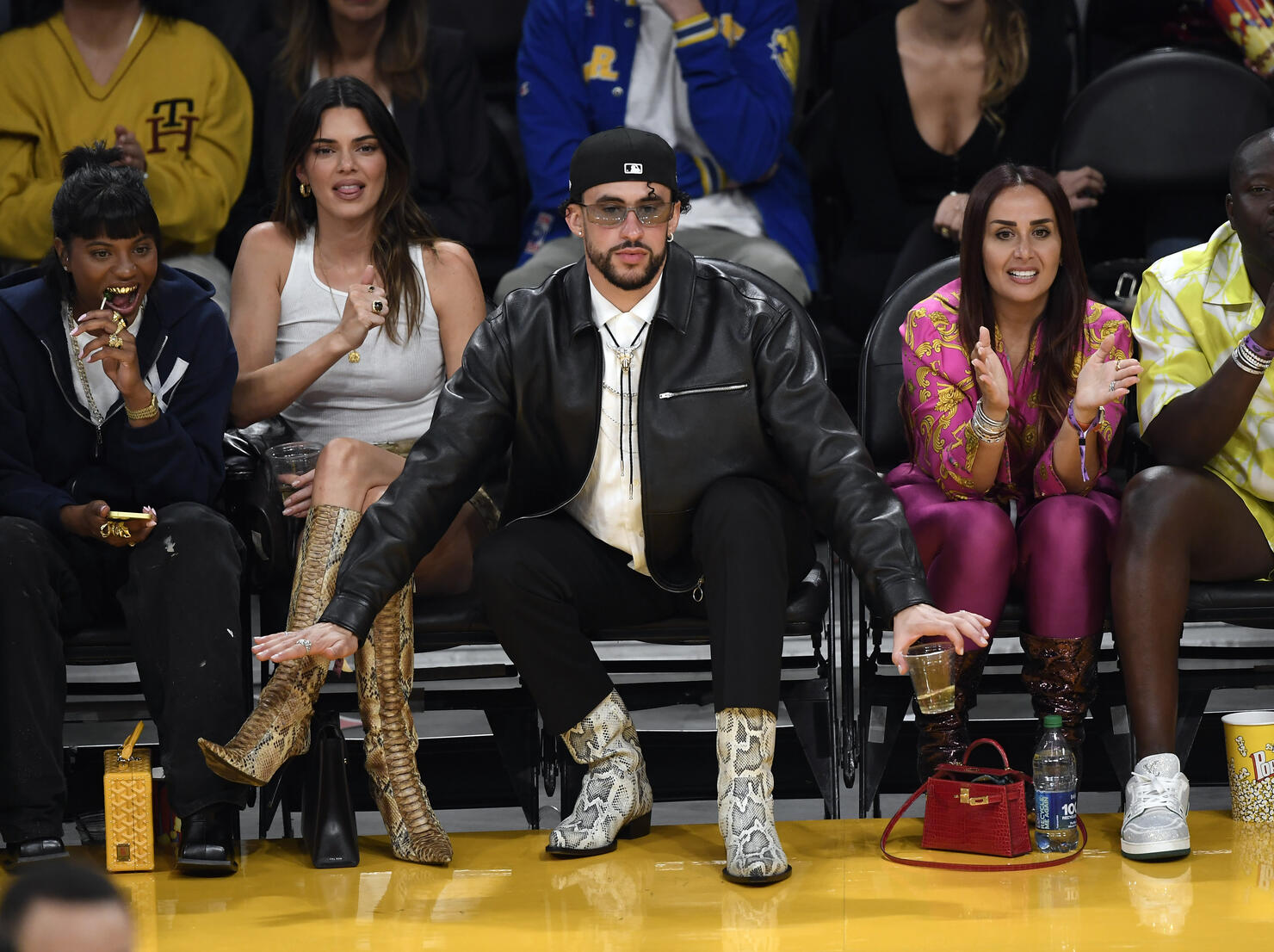 Kendall Jenner, center, sits courtside with Bad Bunny during the second  half in Game 6 of an NBA basketball Western Conference semifinal series  between the Los Angeles Lakers and the Golden State