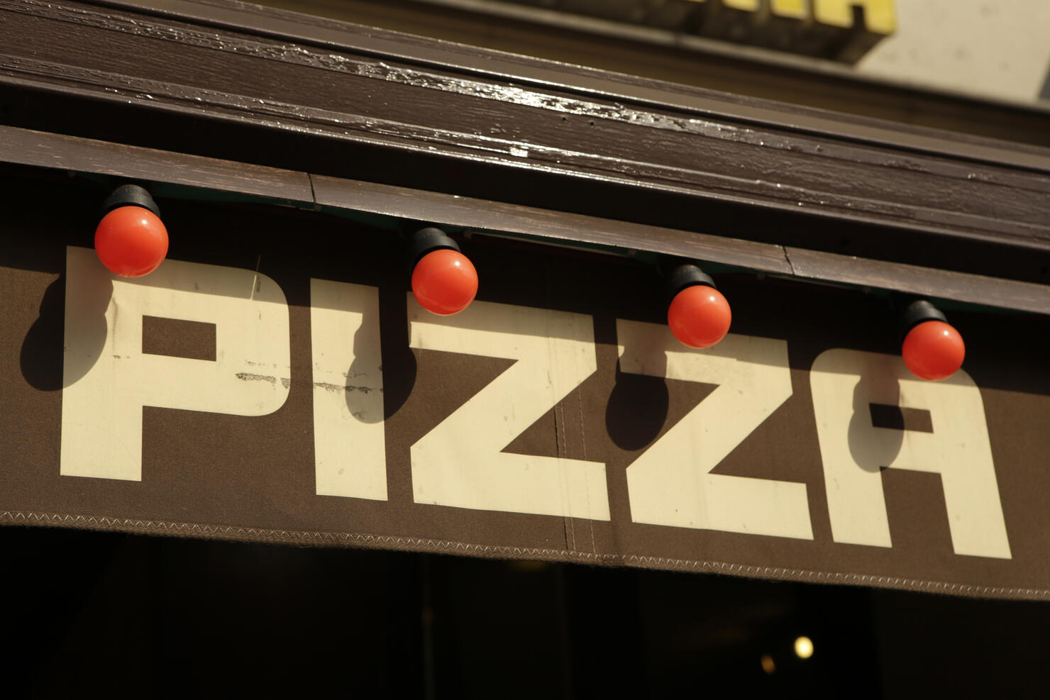 Pizza restaurant sign with red light bulbs in Berlin, Germany