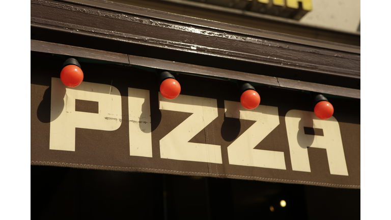 Pizza restaurant sign with red light bulbs in Berlin, Germany