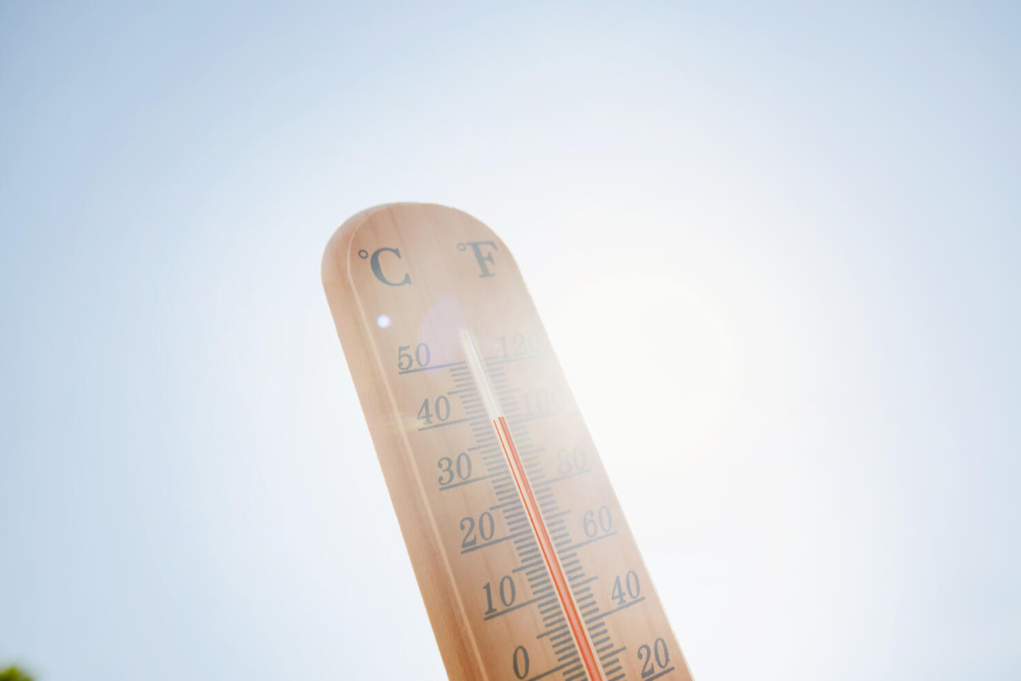 Thermometer against sky and sun