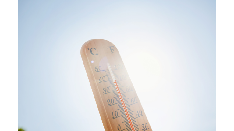 Thermometer against sky and sun