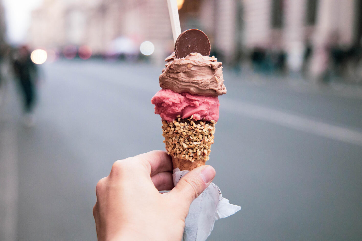 Trying tasty ice cream with levels in Rome during travel vacations.