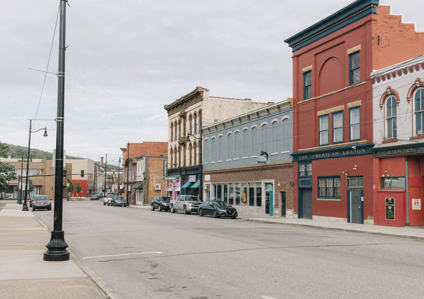 Empty storefronts and buildings along a quiet main street