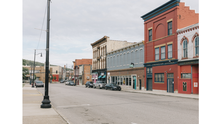 Empty storefronts and buildings along a quiet main street