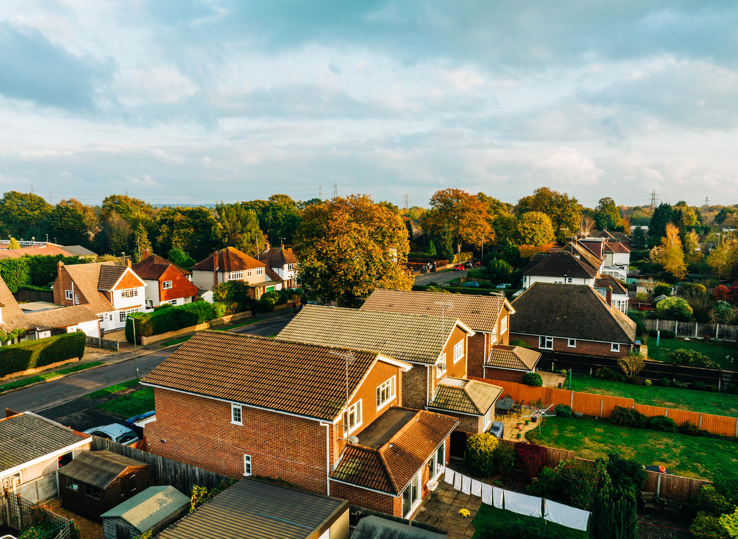 An aerial autumn view of suburban houses and gardens
