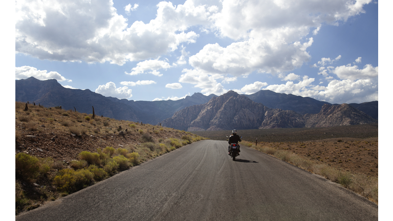 A motorbike rider on an open road