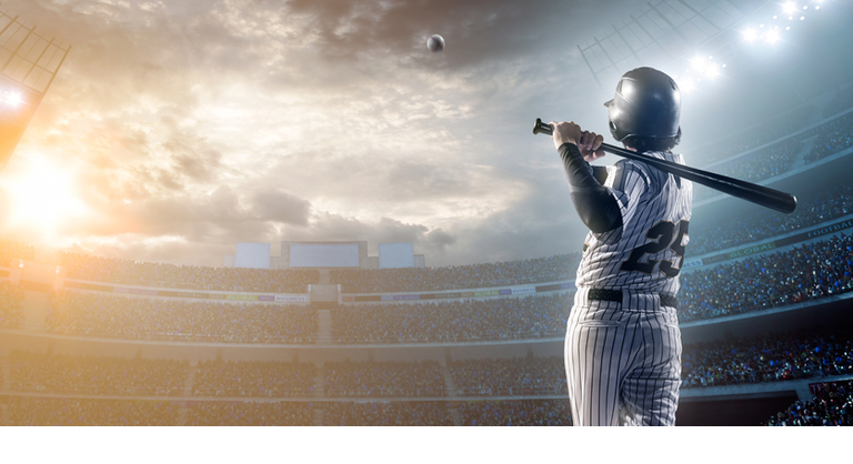 Baseball player hitting a ball in stadium