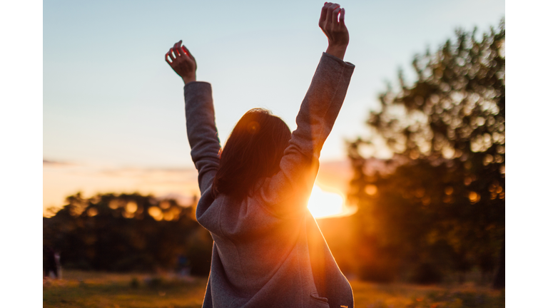 Young Woman Watching Sunset While Enjoying Nature