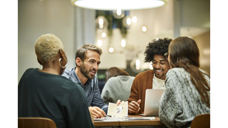 Multi-ethnic coworkers discussing in office