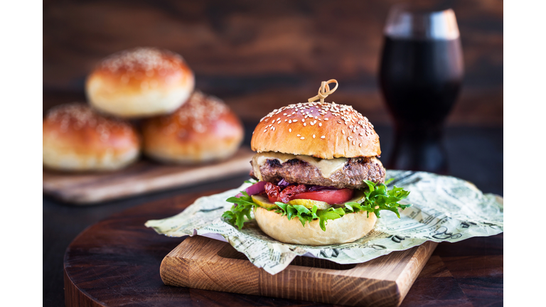 Fresh  homemade burger on wooden background, closeup