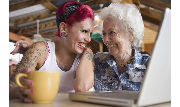 Grandmother and granddaughter looking at laptop