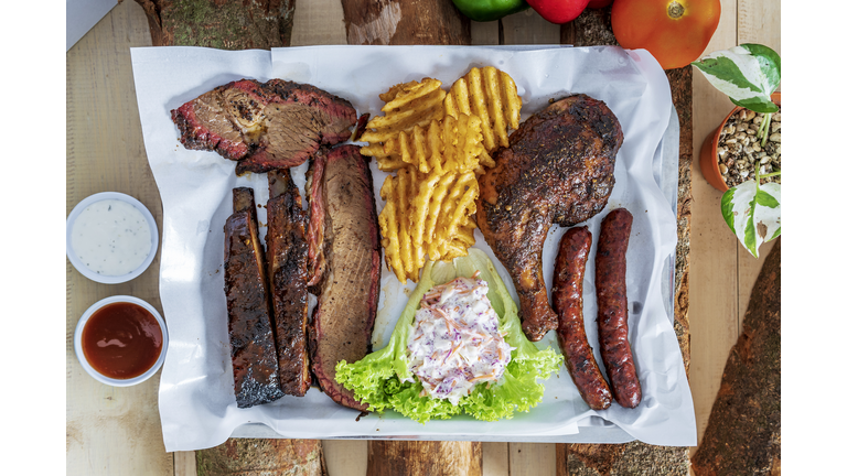 Delicious grilled beef steak and rustic potatoes wedges with vegetable salad served on white plate