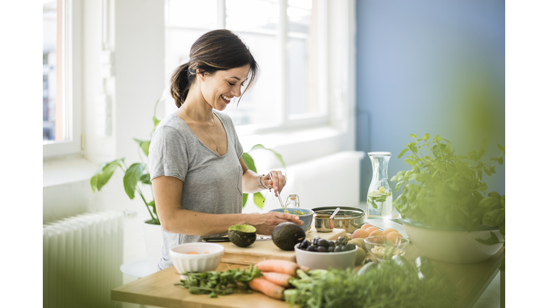 Woman preparing healthy food in her kitchen