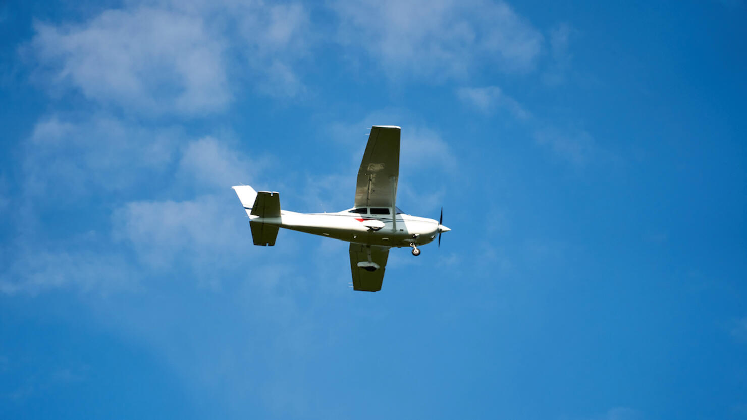 Small airplane isolated on blue, near the Cluj-Napoca. Transylvania, Romania.