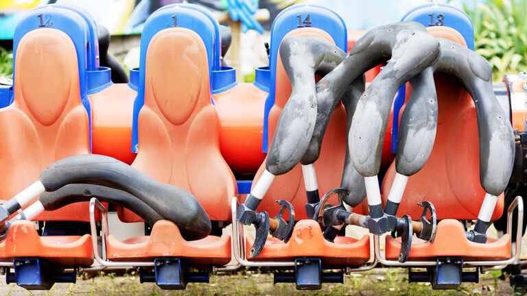 Empty seats of a broken carousel in an amusement park. Broken extreme carousel. Selective focus.