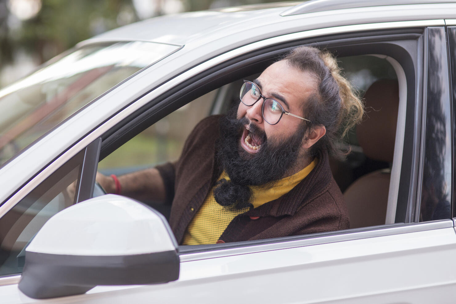 Angry man behind the wheel demonstrating road rage