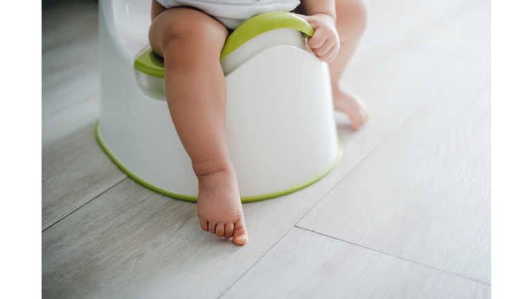 Close up of a toddler sitting on a potty chair on potty training